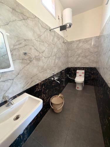 a bathroom with a sink and a toilet at Gravity Groups Core - Sivadurai Residency in Puducherry Airpoert