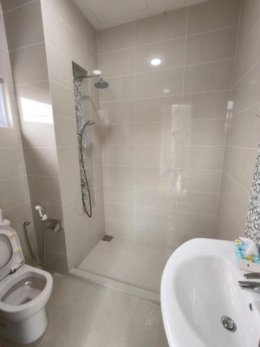 a bathroom with a shower and a toilet and a sink at Penang Gelugor Landed House 4Rooms 3 Bathrooms in Gelugor
