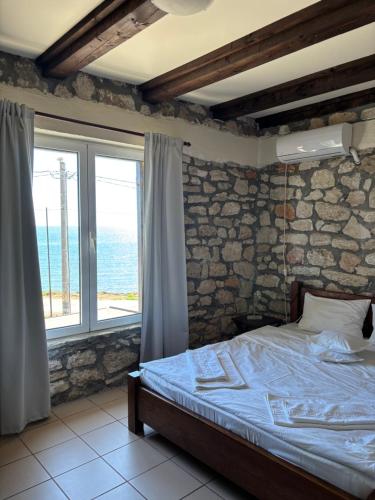 a bedroom with a bed and a large window at CASA MARII Beachfront Villa in 2 Mai in 2 Mai