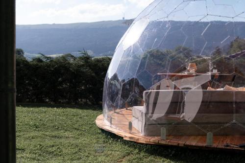 a glass dome sitting on top of a wooden table at Chasseral Sky Dome in Twann
