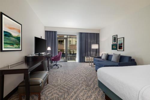 a hotel room with a bed and a desk and a couch at Hampton Inn & Suites - Roanoke-Downtown, VA in Roanoke