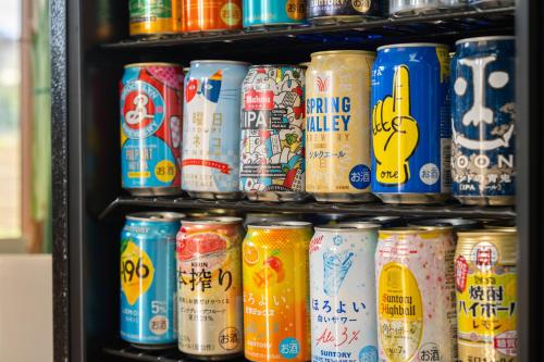a shelf full of cans of drinks in a store at Zekkei in Omachi