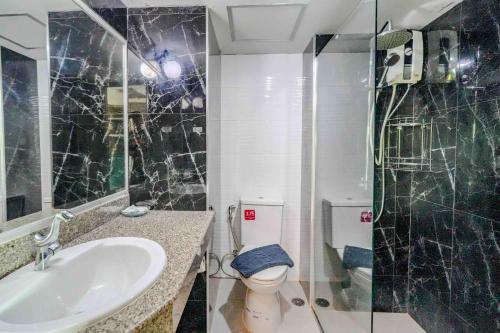 a bathroom with a sink and a toilet and a shower at BCP Hotel in Ban Chang