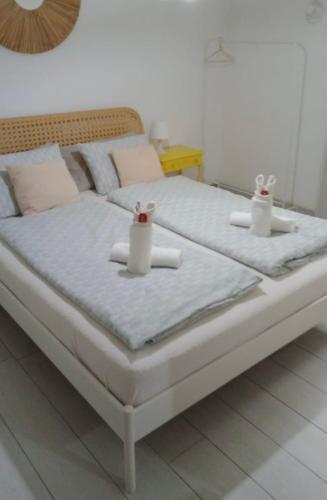 a bed with two candles on top of it at Lake Apartment Ischia White, Lago di Caldonazzo in Tenna 