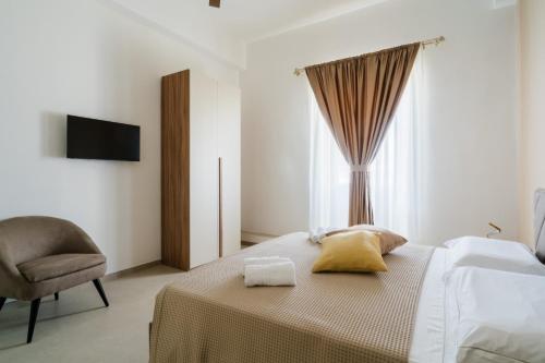 a bedroom with a bed with yellow pillows and a chair at Al Calico in Galatone