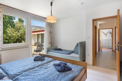 a bedroom with two beds and a window at Ferienhaus Leni in Edertal