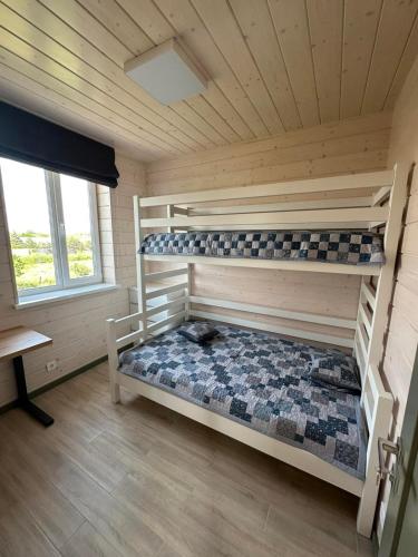 a room with two bunk beds in a cabin at Relax Lux in Mykolaivka