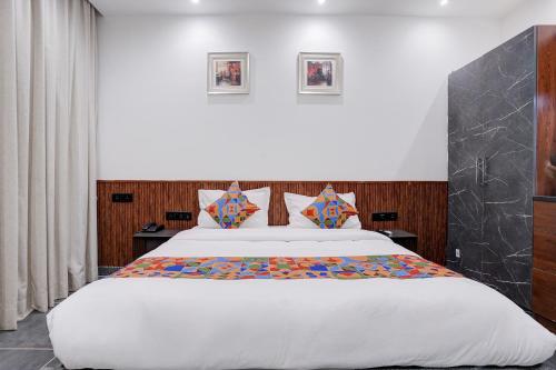 a bedroom with a large white bed in a room at FabHotel JM Residency in Mandrem