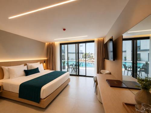 a hotel room with a bed and a view of a pool at The Sign Highlight Hotel in Bodrum City