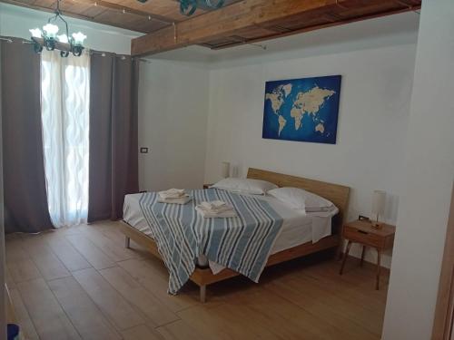a bedroom with a bed with a table and a map on the wall at Casa Dora in Porto Pino