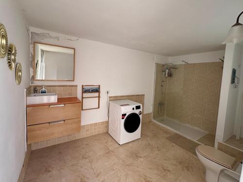 a bathroom with a washing machine and a sink at myplace in Tiagua