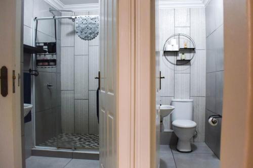 a bathroom with a shower and a toilet at Perfect holiday destination! in Jeffreys Bay