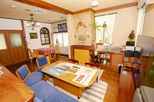a living room with a blue couch and a table at Pension Serenade in Hakuba