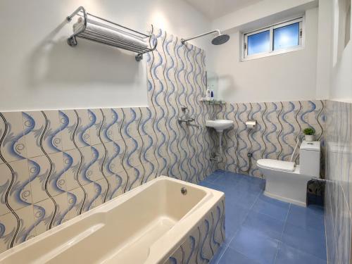 a bathroom with a tub and a toilet at River Side Hotel Pvt Ltd in Tanahun