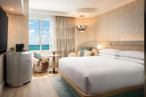 a hotel room with a large bed and a window at Andaz Miami Beach Resort & Spa in Miami Beach