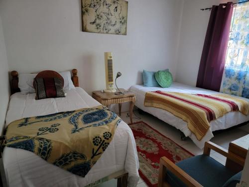 a room with two beds and a chair in it at Ruby's Place in Boscobel