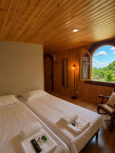 a large bed in a room with a window at Winery & Brewery - Family Guesthouse "Villa Rbona" in Khashuri