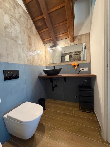 a bathroom with a white toilet and a sink at Antico Borgo in Ancona