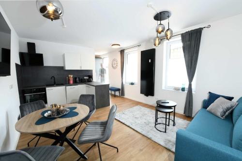 a living room with a blue couch and a table at Apartment Schweriner Lieblingsplatz in Schwerin