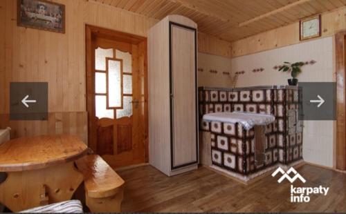a room with a room with a table and a door at Микуличин на долоні 2 in Mykulychyn