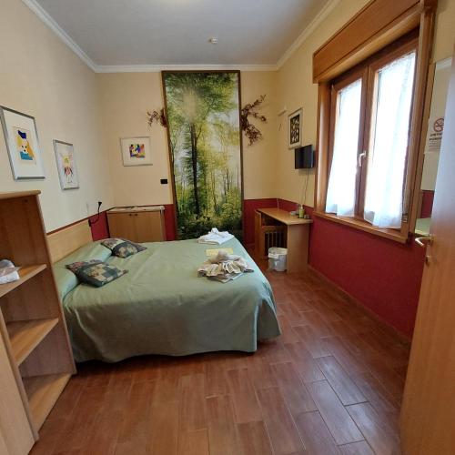 a bedroom with a bed and a large window at Villa Morgante B&B in Pedara
