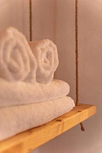 a pile of towels sitting on a wooden shelf at um pouco de campo in Torres Vedras