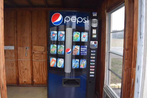 a pepsi vending machine in a room at White Oaks Motel Pennsville/Carneys Point in Pennsville