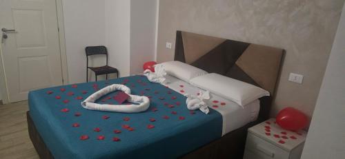 a bedroom with a bed with red hearts on it at Albergo Flaminia Rooms Grottarossa in Rome