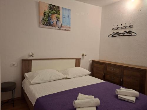 a bedroom with a bed with two towels on it at Villa Frane in Kneževići
