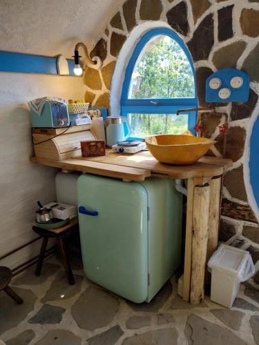 a kitchen with a counter on top of a refrigerator at Nook Hill in Comarnic