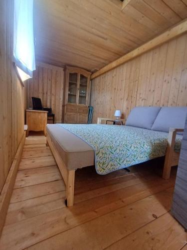 a bedroom with a bed in a wooden room at Jasmine & Rose House in Udine