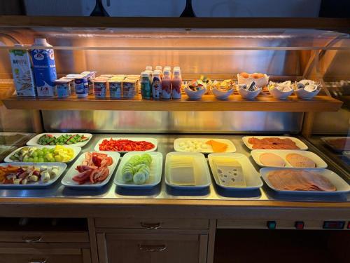 a refrigerator filled with lots of different types of food at Frühstückspension Irschen in Irschen