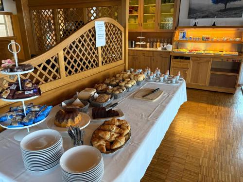 a table with bread and pastries on it in a kitchen at Frühstückspension Irschen in Irschen