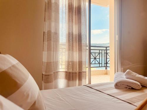 a bedroom with a bed and a window with a view at Seafront Central Luxury Apartment in Samos