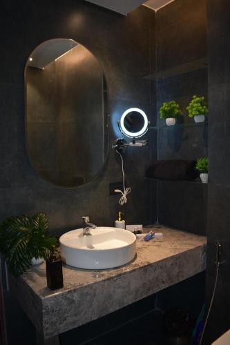 a bathroom with a white sink and a mirror at Galaxy blue sapphire studio in Ghaziabad