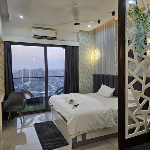 a bedroom with a bed and a large window at Galaxy blue sapphire studio in Ghaziabad