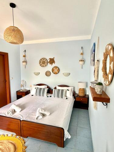 a bedroom with a bed with white sheets and pillows at Sun Thavma Living studio psiloritis in Lístaros