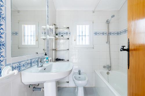 a white bathroom with a sink and a toilet at Chalet Mayor Zenia Beach in Orihuela