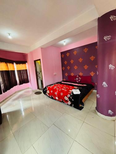 a bedroom with a bed and a purple wall at SB Cottage ooty in Ooty