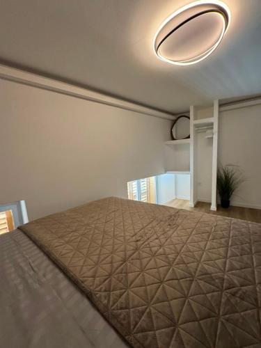 a bedroom with a bed with a brown bedspread at Peregrino Residence in Punat
