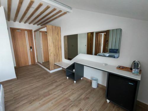 a room with a desk and a large mirror at Telmessos Neva Hotel - Halal-Non Alcoholic All Inclusive-Muhafazakar Hotel in Oludeniz