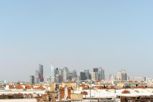 a view of a city skyline with tall buildings at Appart Hôtel Résidence Courcelle in Levallois-Perret