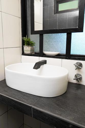 a white sink on a counter in a bathroom at Aman Dan Laut in Perhentian Islands