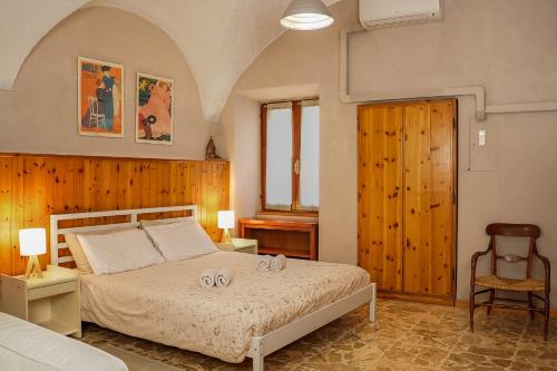 a bedroom with a bed and a chair at La corte del Lago in Sulzano