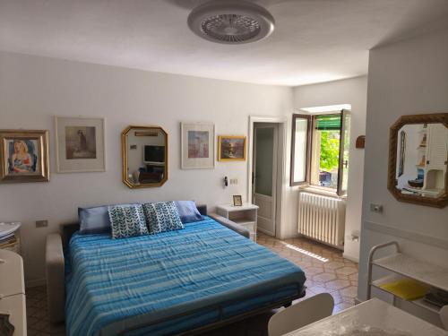 a bedroom with a bed and a mirror and a sink at Maddalena House in Varenna