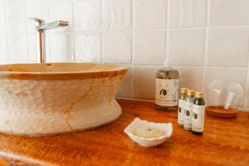 a wooden counter with a sink and bottles of alcohol at Podere Sant'Elena in San Gimignano