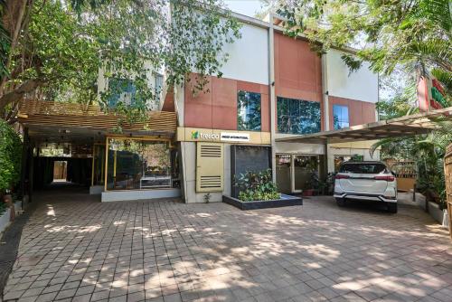 a building with a car parked in front of it at Treebo Amber International Mumbai Airport T2 in Mumbai