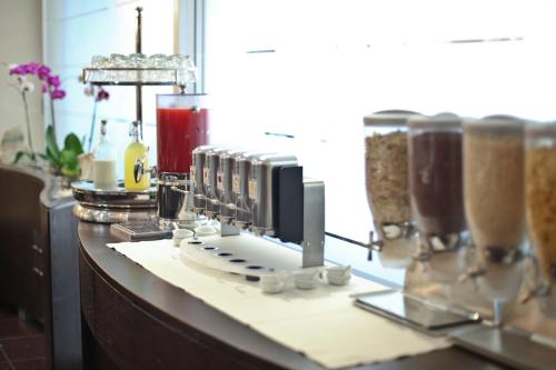 a counter with a bunch of milkshakes on it at Millennhotel in Bologna