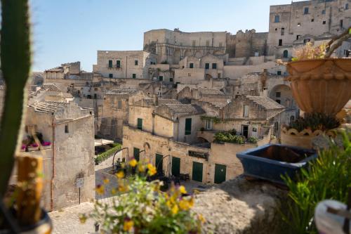 a view of a city with buildings and flowers at Da Ida - Matera Cento Storico - Sassi in Matera