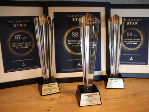 three awards sitting on top of a table at ibis budget Rennes Rte Lorient in Rennes